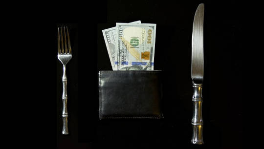 How Does Greed Affect Your Life? And How To Let Go a table setting with a knife and fork and a wallet full of money where the plate usually would be