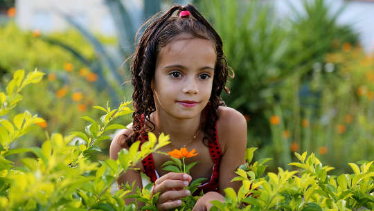 Open the Floodgates of Abundance and Inner Peace young girl in a field of plants and flowers