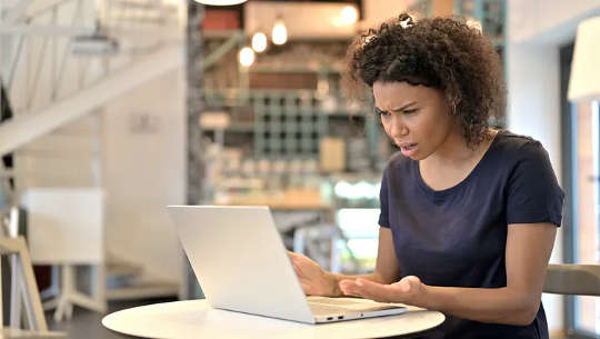 Keep On Keeping On When Facing The Flood Of Bad News upset woman sitting in front of her open laptop computer