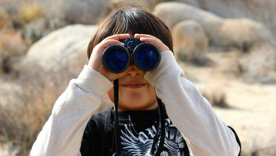 The Power of Five: Five Weeks, Five Months, Five Years young boy looking through binoculars