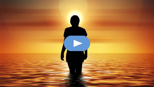 Understanding 5th Dimension Consciousness and the Divine Feminine Within Us woman standing in the ocean looking at the rising sun