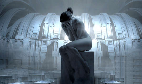 a statue of an unclothed woman sitting on a pedestal