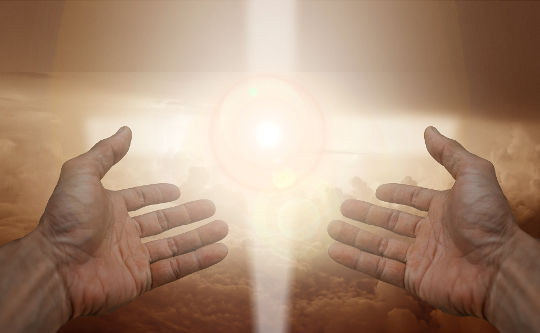 A Rare Example of Compassion open hands with radiant white light in the background