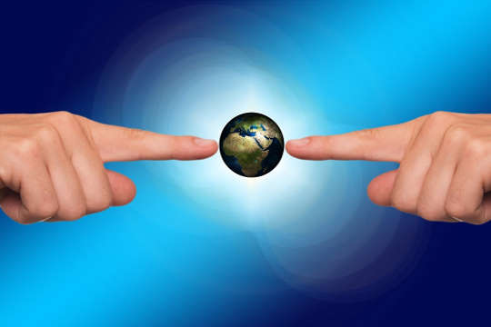 Today's Inspiration: October 25, 2022 two hands pointing and touching planet earth