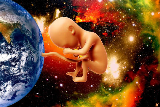 Gratitude: The Missing Ingredient in Our Life and Our World? a picture of Planet Earth with a baby linked to it by an umbilical cord