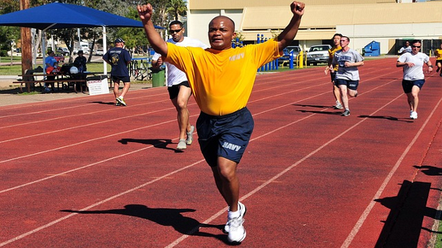Black athlete winning the race at a track meet