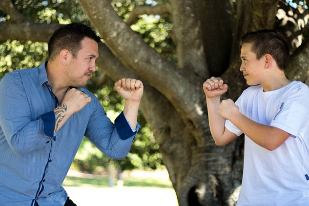 The Father-Son Wound and How To Heal It a father and son facing each other wearing boxing gloves