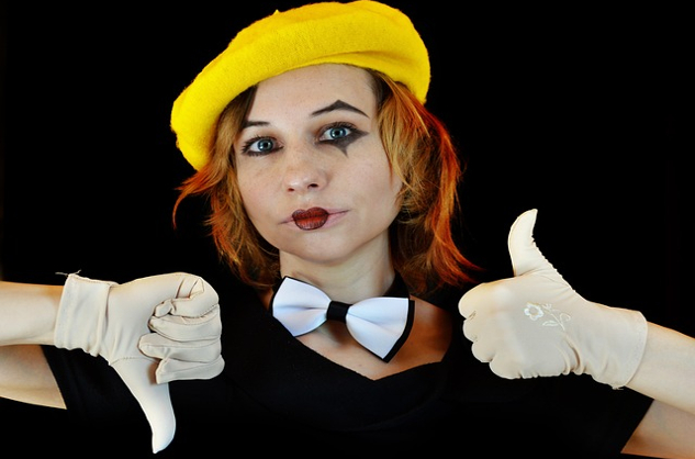 Are Your Expectations of Others Fantasy or Reality? a woman with clown-like makeup making a thumbs up and a thumbs down gesture
