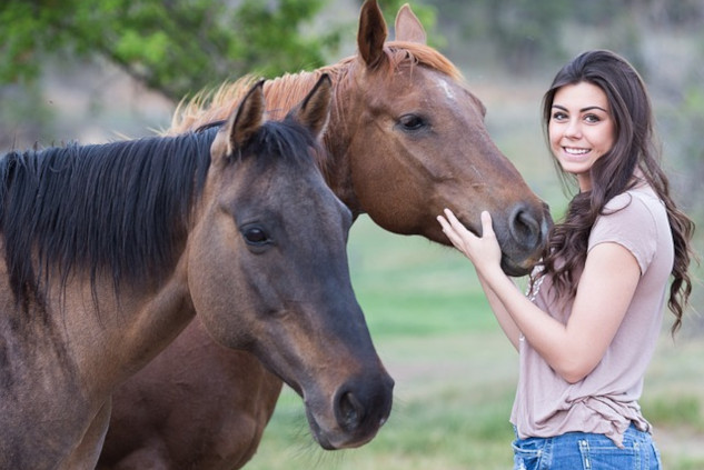 What Horses Can Teach Us About Life a young woman with two horses