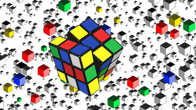 InnerSelf Magazine: January 27, 2025 a rubik cube in progress, with a whole bunch of single cubes spread in chaos all around it.
