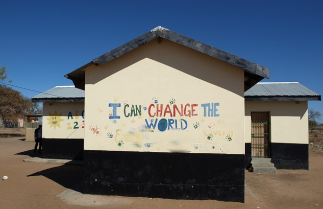 InnerSelf Magazine: April 21, 2025. Picture of a school in Africa with the words written on the building: I can change the world. Image by henkpijper from Pixabay.