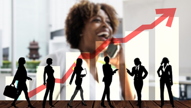 a female executive with a group of people in front of her