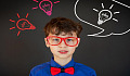 A schoolboy wearing red framed glasses and a red bow-tie. Image by Victoria from Pixabay&nbsp;