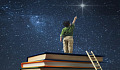 a young boy standing on a stack of books reaching for the North Star