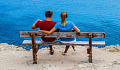 A couple sitting on a bench with the woman's arm around the shoulders of the man.&nbsp;Image by Dimitris Vetsikas from Pixabay.&nbsp;